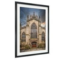 A large, ornate stone church with a tall spire and intricate architectural details, set against a dramatic sky.