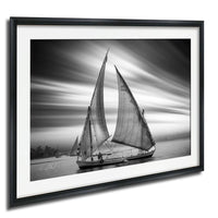 This luxury black and white fine art photograph captures a felucca sail boat drifting along the Nile River at sunset near Luxor, Egypt. Soft fog and minimalist composition create a timeless, monochrome aesthetic rooted in Egyptian river culture. Ideal for collectors and interior designers seeking refined, museum-quality wall art that embodies elegance, simplicity, and enduring calm. black white nile river art, felucca sailboat wall decor, luxor egypt monochrome print, luxury minimalist wall art