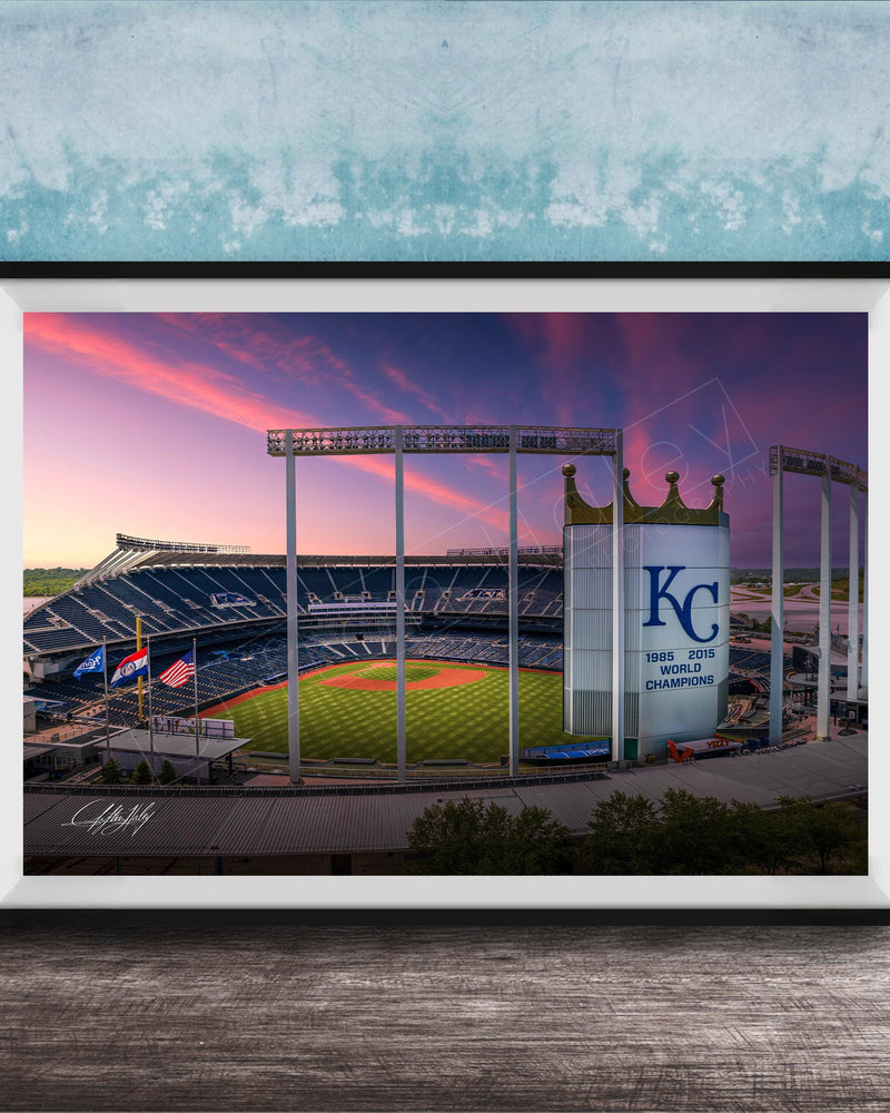 A framed photograph of a baseball stadium at sunset, with the Kansas City Royals logo prominently displayed.