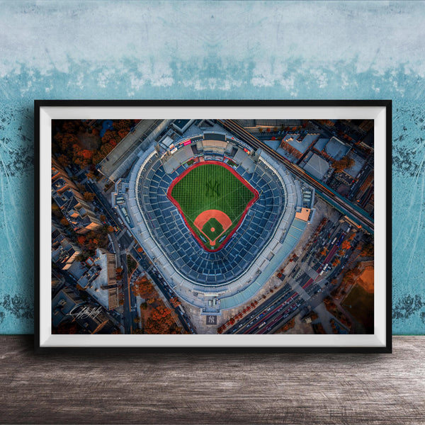 The image is an aerial view of a baseball stadium, specifically the New York Yankees stadium, with the field and surrounding buildings visible.