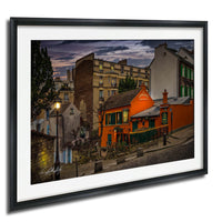 a charming street scene in Paris, France, with colorful buildings, a cobblestone street, and a warm, inviting atmosphere.