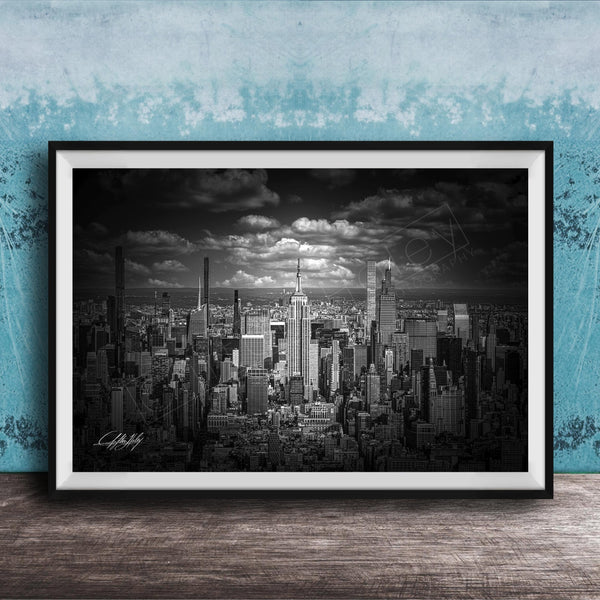 A black and white photograph of a cityscape, likely New York, with numerous tall buildings and skyscrapers in the background.