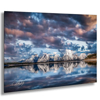 a serene landscape with snow-capped mountains reflected in a calm lake, set against a dramatic sky with clouds.