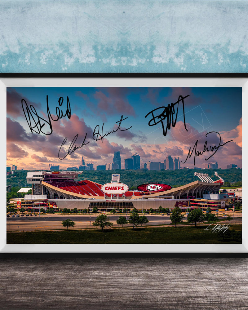 A framed photograph of a football stadium with the word "CHIEF" prominently displayed, along with the signatures of several people.