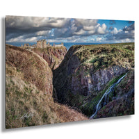 a dramatic landscape with a castle perched atop a cliff, overlooking a waterfall cascading down the rocky terrain below.