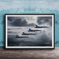 four blue and yellow fighter jets flying in formation against a cloudy sky.