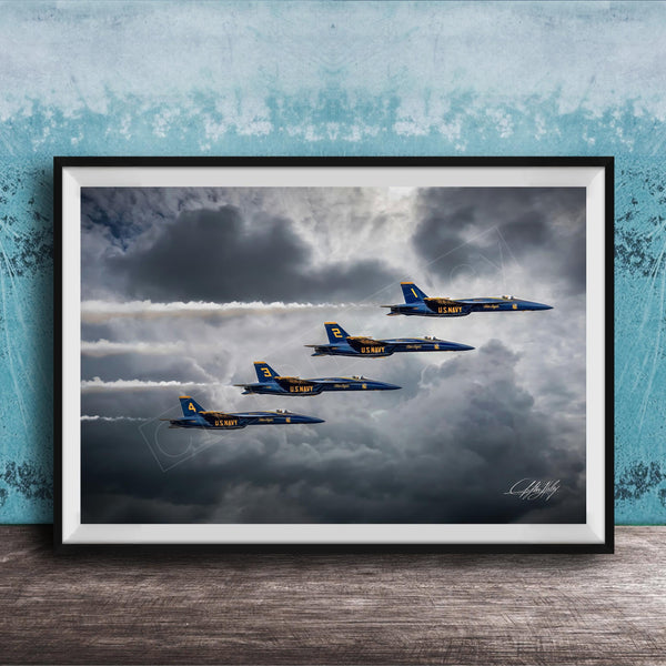 four blue and yellow fighter jets flying in formation against a cloudy sky.