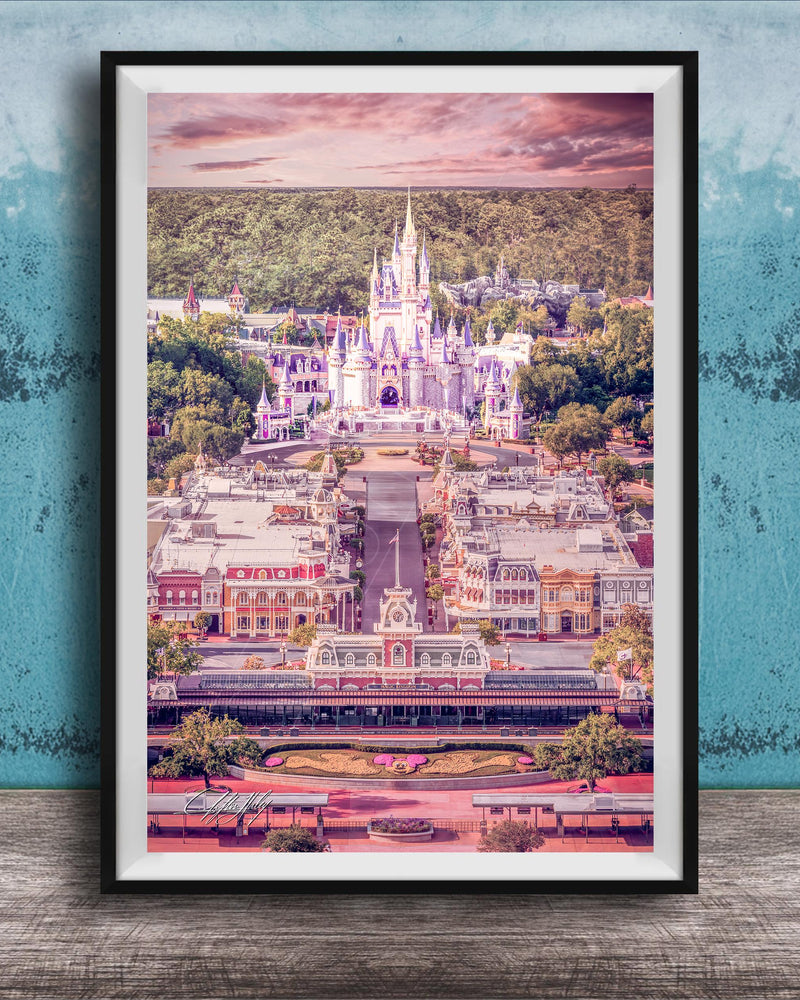 A framed image depicting a fantastical castle-like structure surrounded by a colorful, whimsical landscape, with a cloudy sky in the background.