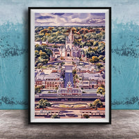 A framed illustration depicting a fantastical cityscape with a castle-like structure in the center, surrounded by lush greenery and a winding road.