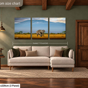 The image is a livingroom size chart that includes a large painting of an elephant in a field, a sofa, a rug, and a wooden door.