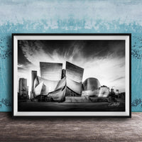 A black and white photograph of the Walt Disney Concert Hall in Los Angeles, California, with its distinctive curved roof and modern architectural design.