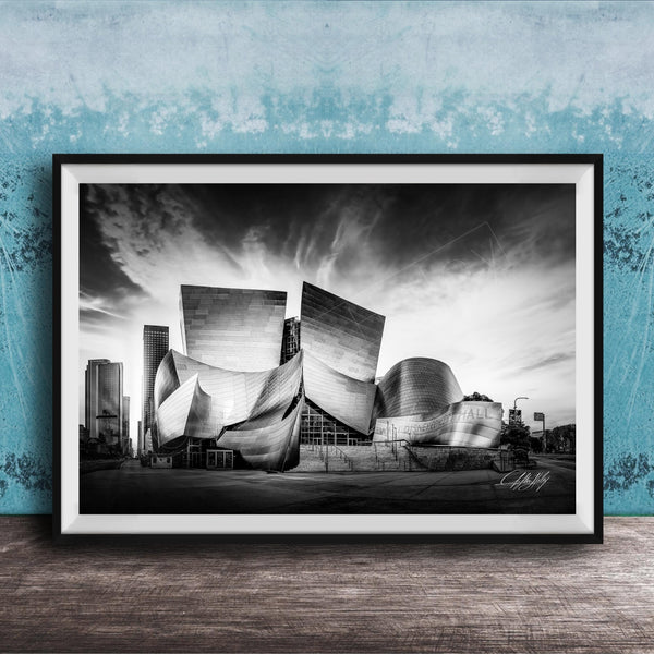 A black and white photograph of the Walt Disney Concert Hall in Los Angeles, California, with its distinctive curved roof and modern architectural design.