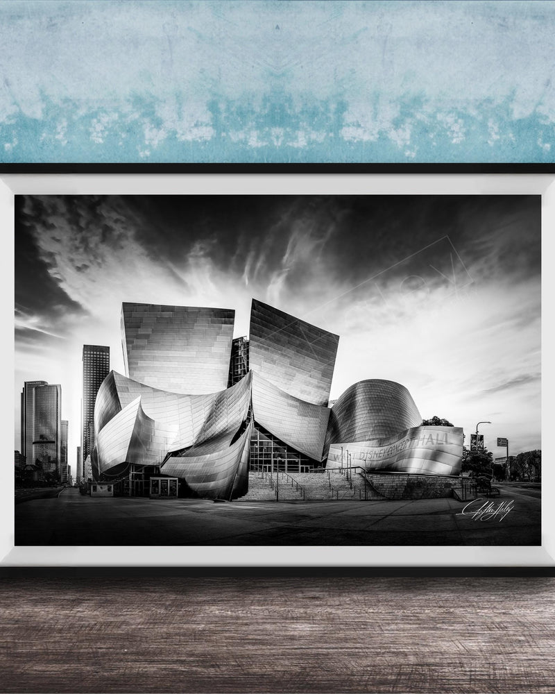 A black and white photograph of the Walt Disney Concert Hall in Los Angeles, California, with its distinctive curved roof and modern architectural design.