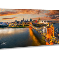Cincinnati Ohio wall art, Ohio river aerial photography, urban skyline sunset print, Roebling bridge historic photo, Queen City home decor, Midwest travel wall art, Cincinnati sports stadiums photo, suspension bridge cityscape art, downtown Cincinnati aerial view, vibrant sunset city wall print, skyline over river fine art photo, architectural bridge photography, Cincinnati panoramic art print, Ohio city golden hour photo, Midwest urban skyline decor