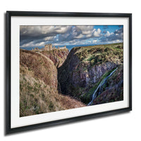 a picturesque landscape with a castle perched atop a cliff, overlooking a valley with a waterfall cascading down the rocky terrain.