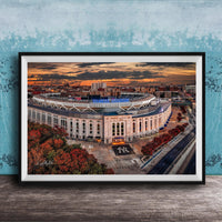 The image is a framed photograph of the Yankee Stadium in New York City, with a stunning sunset in the background.
