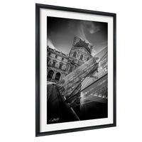 A black and white photograph of a historic building with a dome, framed in a black frame and hanging on a wall.