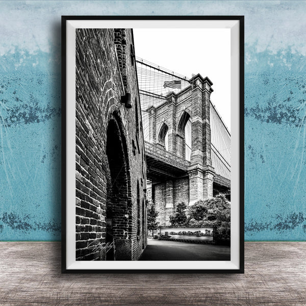 A black and white photograph of the Brooklyn Bridge, with the iconic structure and its arches prominently featured.
