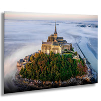 a large, multi-tiered castle perched on a small island, surrounded by a lush, green landscape.