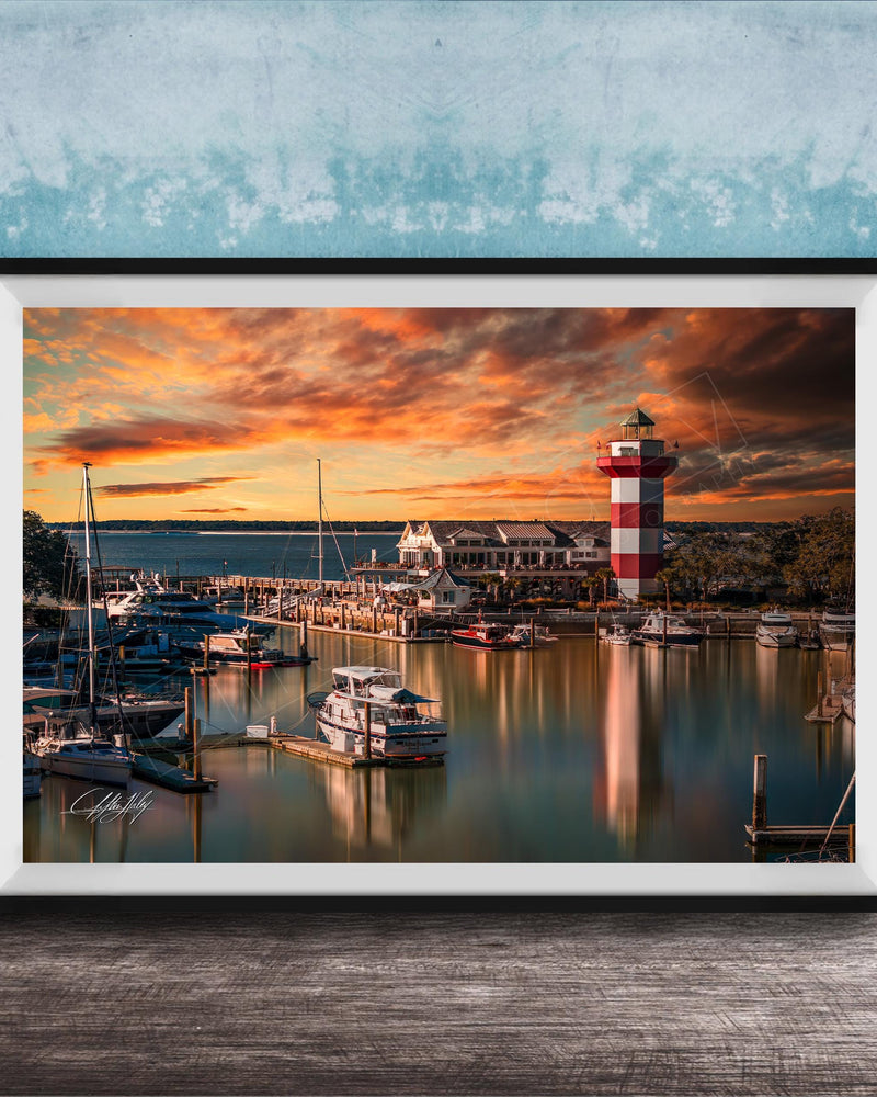 a serene harbor scene at sunset, with boats docked in the calm waters and a lighthouse standing tall in the background.