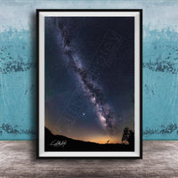 The image is a framed photograph of a night sky with the Milky Way galaxy, a stunning celestial display.