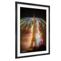 a tall tower with a large, colorful fireworks display lighting up the night sky behind it.