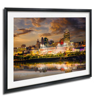 a city skyline at night, with tall buildings illuminated by colorful lights. The city is reflected in the water below, creating a beautiful and vibrant scene.