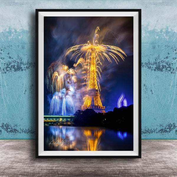 a vibrant fireworks display over a body of water, with the Eiffel Tower and other illuminated structures visible in the background.
