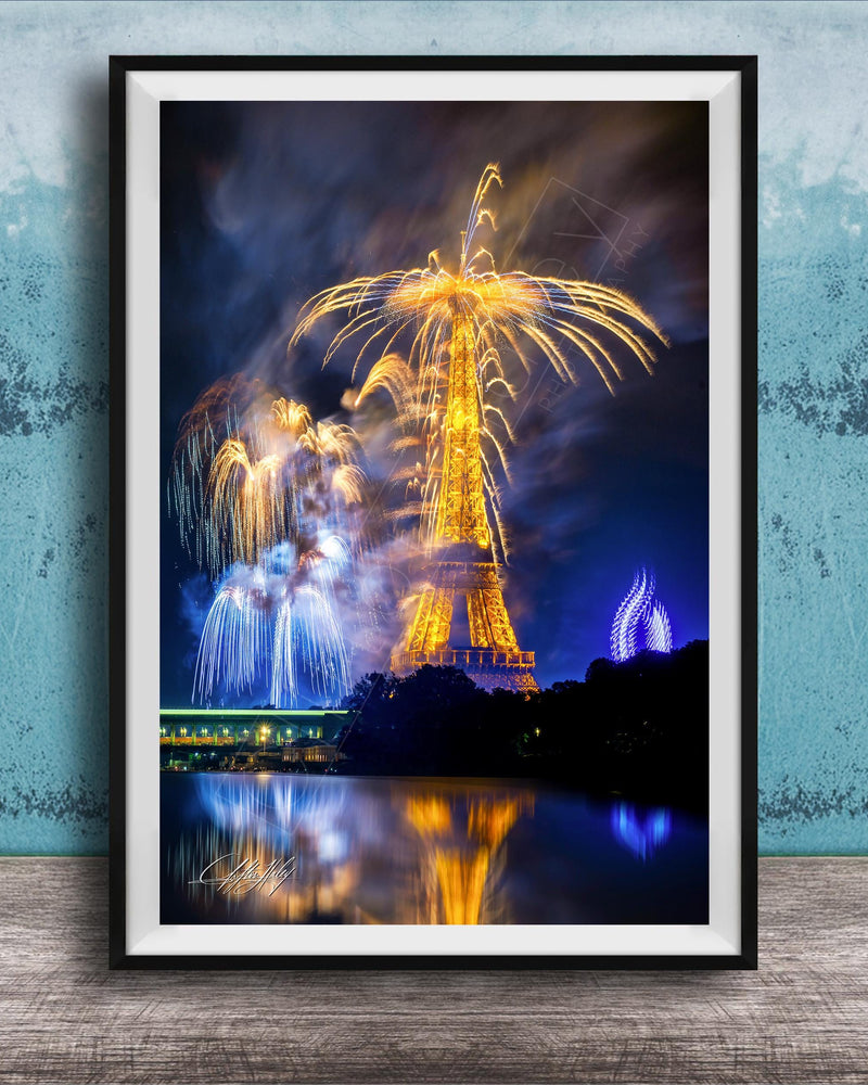 a vibrant fireworks display over a body of water, with the Eiffel Tower and other illuminated structures visible in the background.