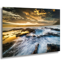 a dramatic natural landscape with a powerful waterfall cascading into a deep blue ocean under a dramatic sky filled with clouds and a stunning sunset.