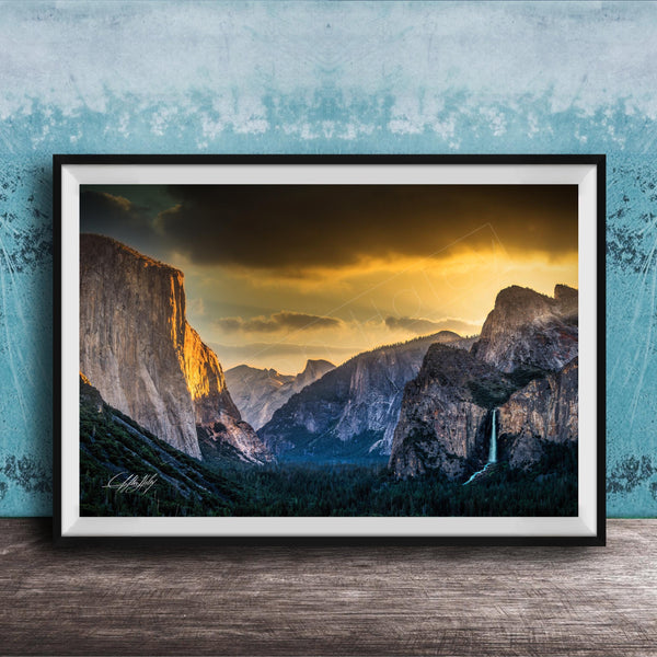 The image is a framed photograph of a breathtaking mountainous landscape at sunset, with dramatic clouds and a waterfall in the foreground.