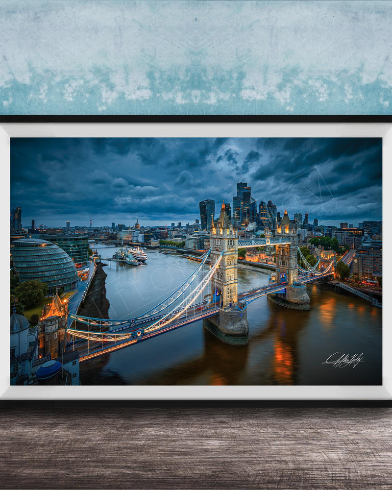A framed photograph of the London skyline at night, featuring the iconic Tower Bridge and the River Thames.