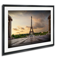 the Eiffel Tower, a famous landmark in Paris, France, with a cloudy sky in the background.
