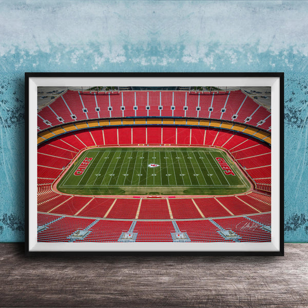 The image is a framed photograph of a football stadium, specifically the Kansas City Chiefs stadium, with a focus on the field and seating areas.