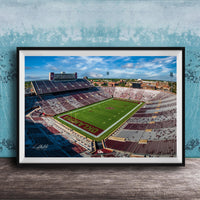 The image is a framed photograph of a football stadium, likely taken from an aerial perspective.