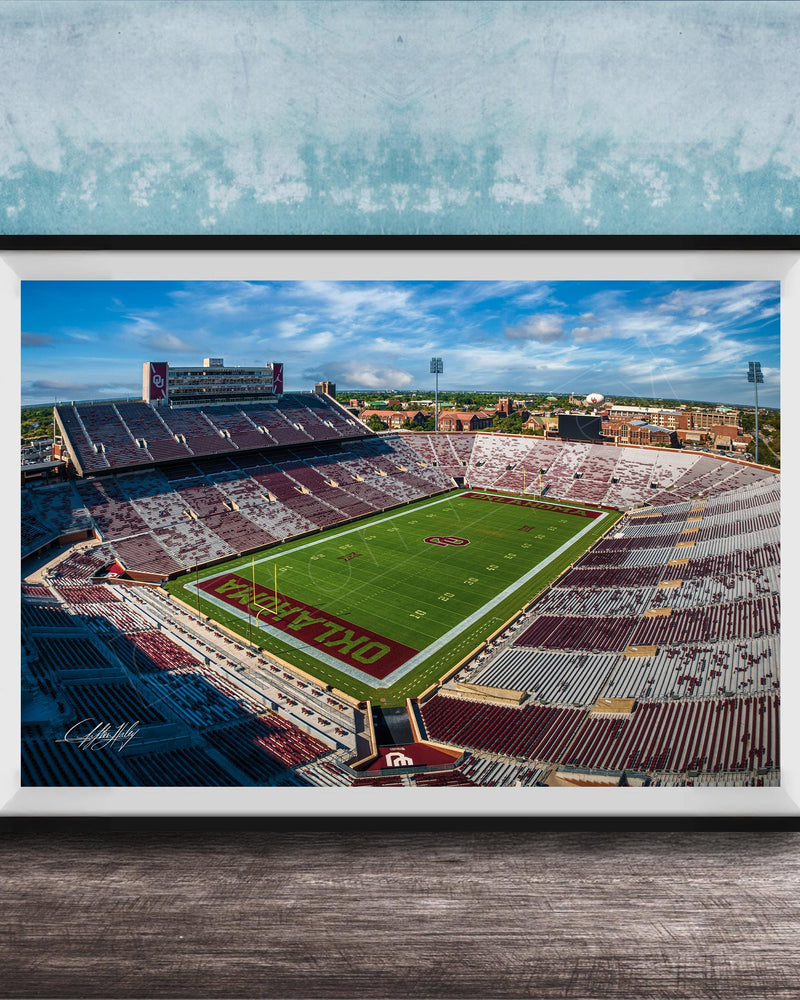 The image is a framed photograph of a football stadium, likely taken from an aerial perspective.