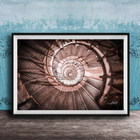 The image is a framed photograph of a spiral staircase, with the steps arranged in a spiral pattern and the image captured from a low angle.
