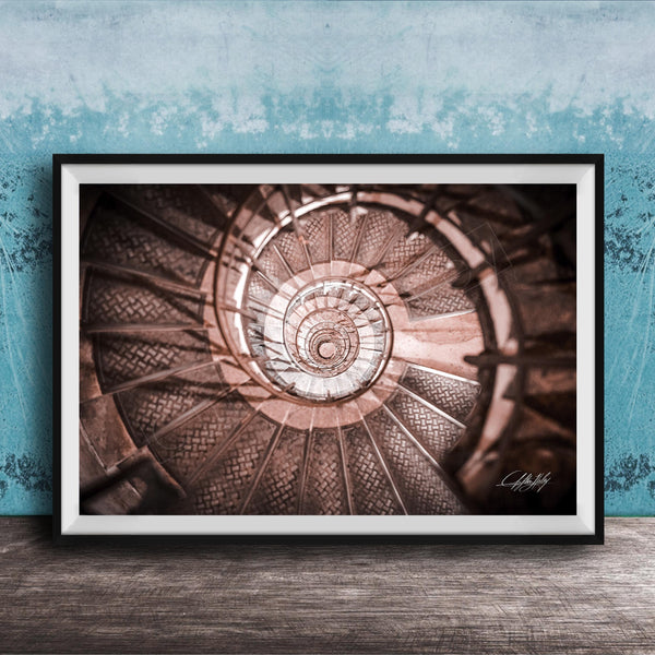 The image is a framed photograph of a spiral staircase, with the steps arranged in a spiral pattern and the image captured from a low angle.