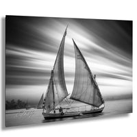 This luxury black and white fine art photograph captures a felucca sail boat drifting along the Nile River at sunset near Luxor, Egypt. Soft fog and minimalist composition create a timeless, monochrome aesthetic rooted in Egyptian river culture. Ideal for collectors and interior designers seeking refined, museum-quality wall art that embodies elegance, simplicity, and enduring calm. black white nile river art, felucca sailboat wall decor, luxor egypt monochrome print, luxury minimalist wall art