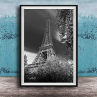 A black and white photograph of the Eiffel Tower in Paris, France, with a blue and white background.