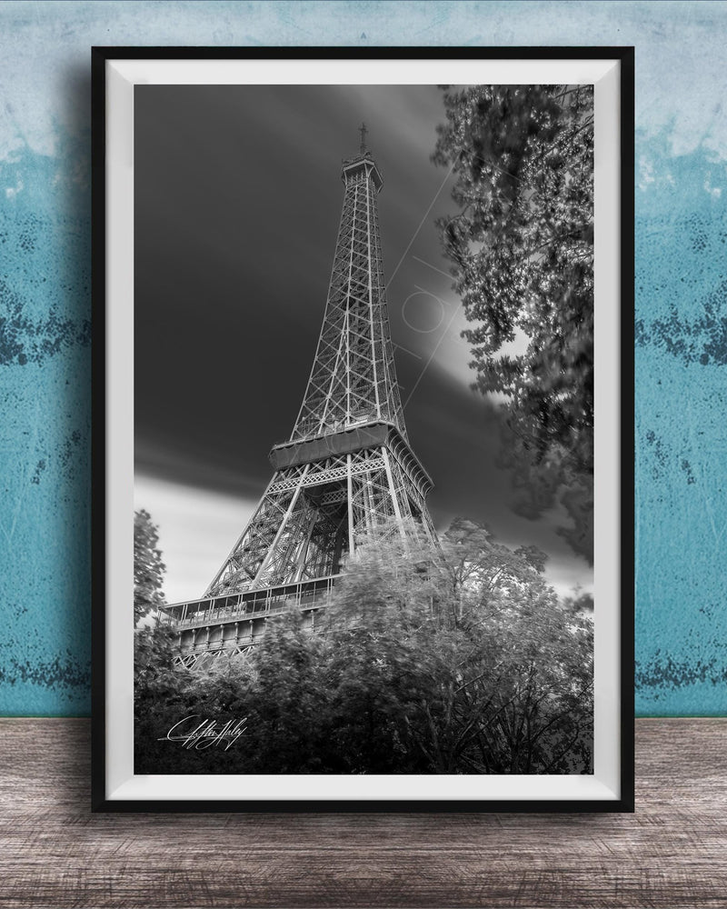 A black and white photograph of the Eiffel Tower in Paris, France, with a blue and white background.