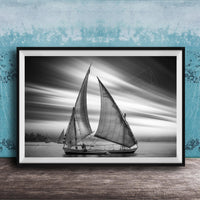 This luxury black and white fine art photograph captures a felucca sail boat drifting along the Nile River at sunset near Luxor, Egypt. Soft fog and minimalist composition create a timeless, monochrome aesthetic rooted in Egyptian river culture. Ideal for collectors and interior designers seeking refined, museum-quality wall art that embodies elegance, simplicity, and enduring calm. black white nile river art, felucca sailboat wall decor, luxor egypt monochrome print, luxury minimalist wall art