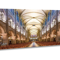 a grand cathedral with a high vaulted ceiling, ornate architectural details, and rows of wooden pews leading to a central altar.
