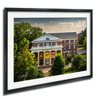 A framed photograph of the historic Peabody Hall building, a brick structure with a prominent pediment and columns, surrounded by lush greenery.