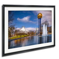 A framed photograph of the iconic Space Needle in Nashville, Tennessee, with a fountain in the foreground and a blue sky with clouds in the background.