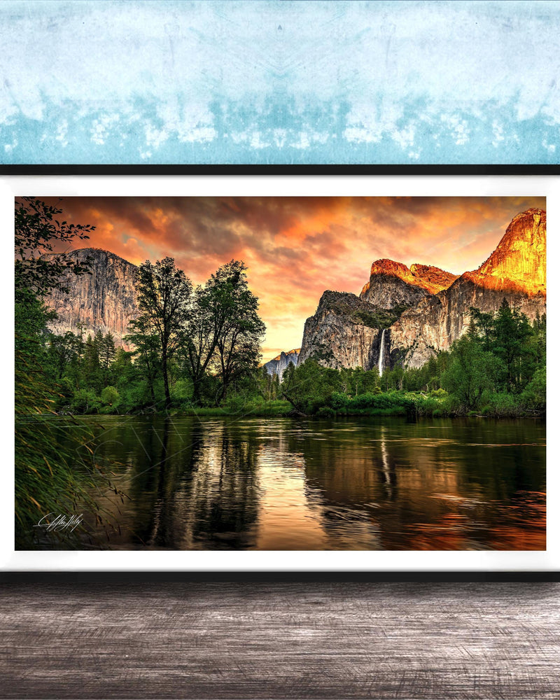 a serene landscape with a calm lake reflecting the vibrant colors of the sky, surrounded by lush greenery and towering mountains.