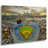 An aerial view of a baseball stadium with a city skyline in the background.