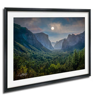 a breathtaking mountainous landscape with a full moon illuminating the scene.