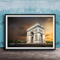 a large, ornate archway with intricate carvings, set against a dramatic sky with clouds and a warm, orange glow.