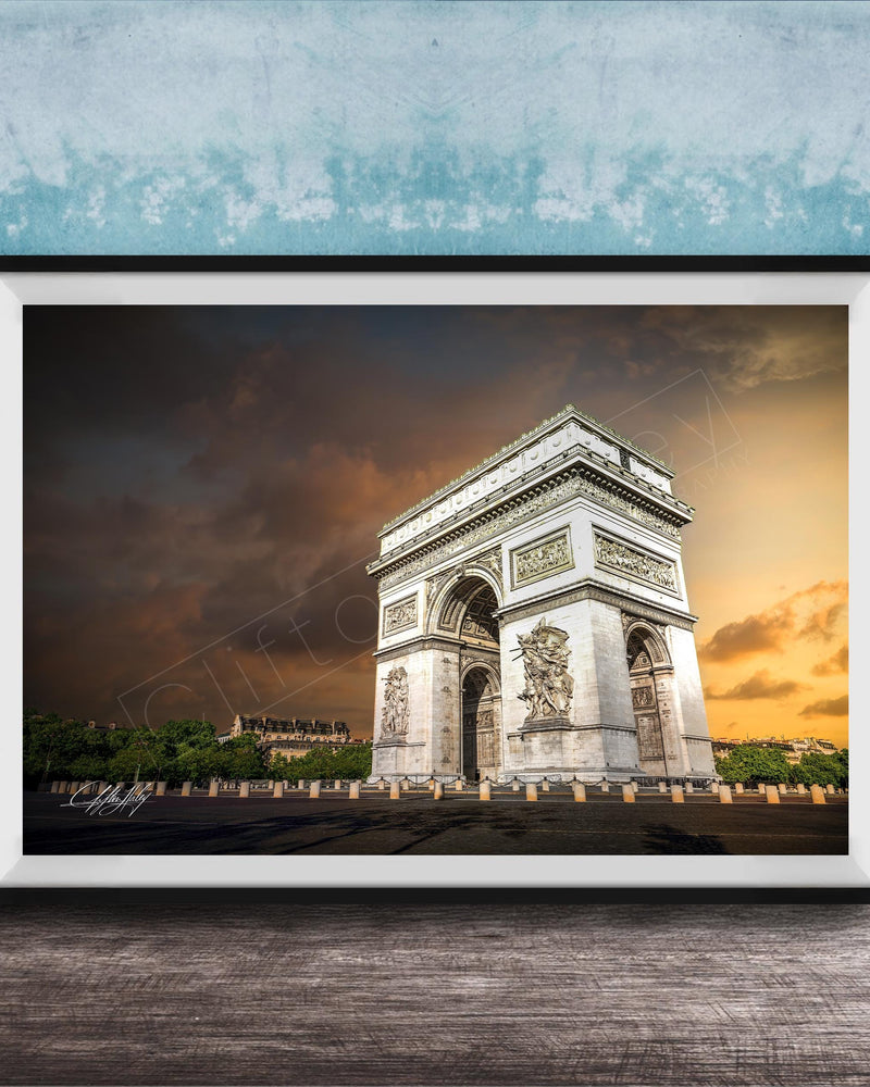 a large, ornate archway with intricate carvings, set against a dramatic sky with clouds and a warm, orange glow.